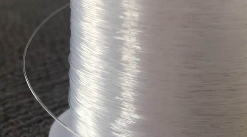 image of a clear white fishing line spool