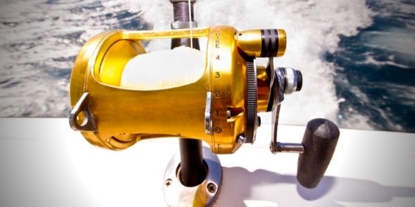 Image of a gold colored spincast reel