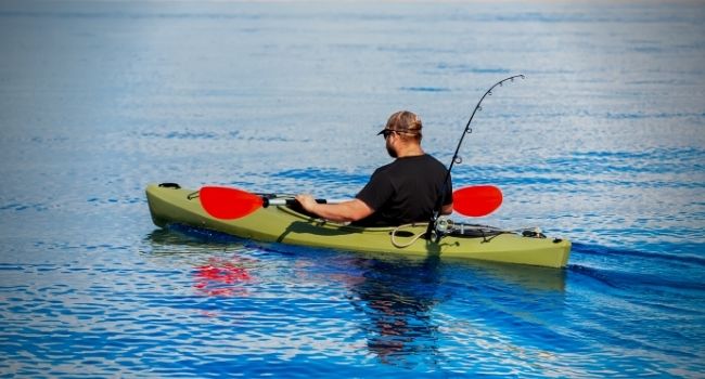 Image of a Fisherman sitting inside Kayak