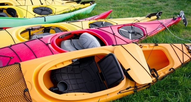 Image of six different colored fishing kayaks